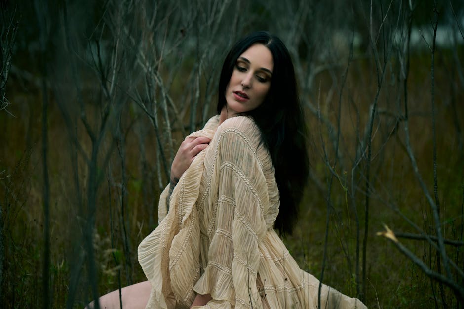 A woman in a flowing dress in a forest setting representing natural fashion