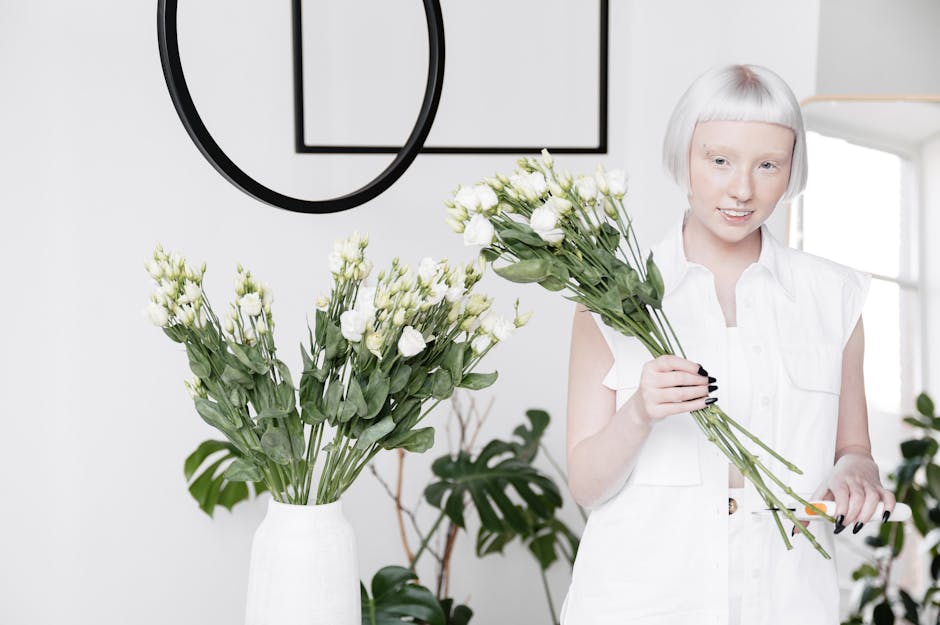 A minimalist professional with white hair holding a bouquet of flowers